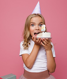 girl celebrating her birthday pink background